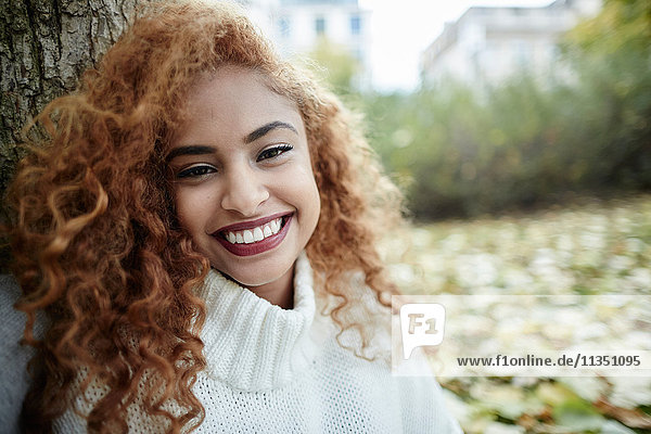 Portrait einer lächelnden Teenagerin im Park