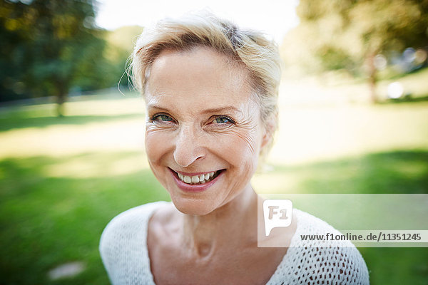 Portrait of smiling mature woman in a park