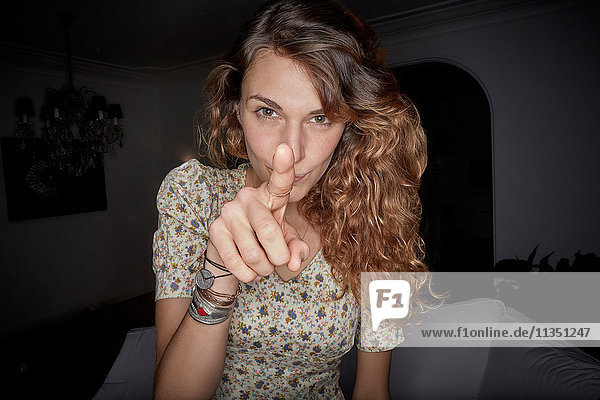 Young woman pointing her finger