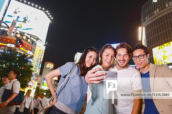 Caucasian couple enjoying sightseeing with Japanese friends in Tokyo  Japan