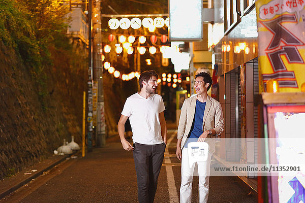 Caucasian man enjoying nightlife in Tokyo with Japanese friend  Japan