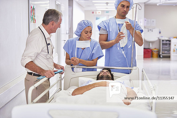 Doctors surrounding patient in hospital bed