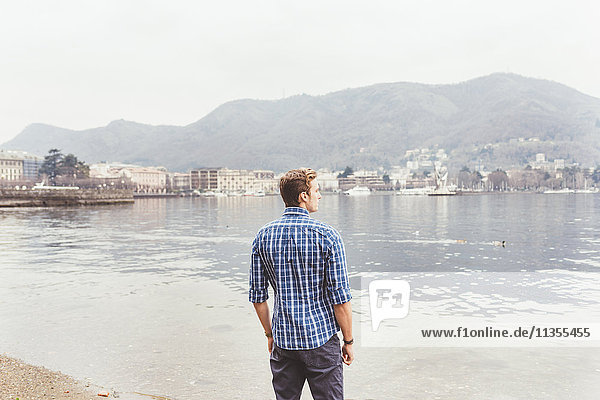 Young man looking out from lakeside  Lake Como  Italy