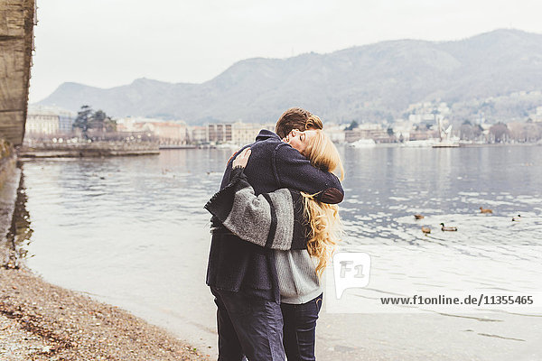 Young couple hugging each other on lakeside  Lake Como  Italy