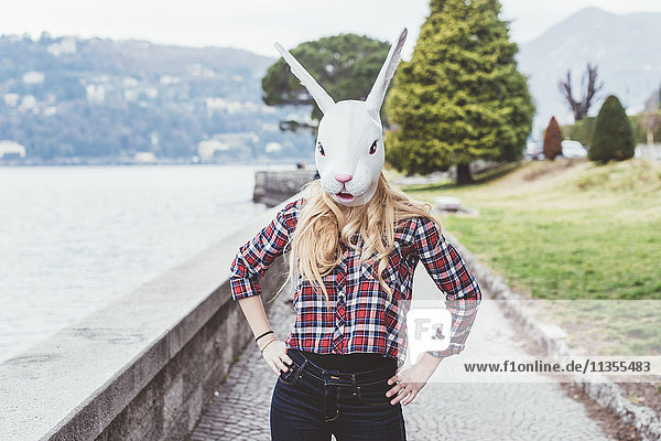 Portrait of woman wearing rabbit mask with hands on hips  Lake Como  Italy