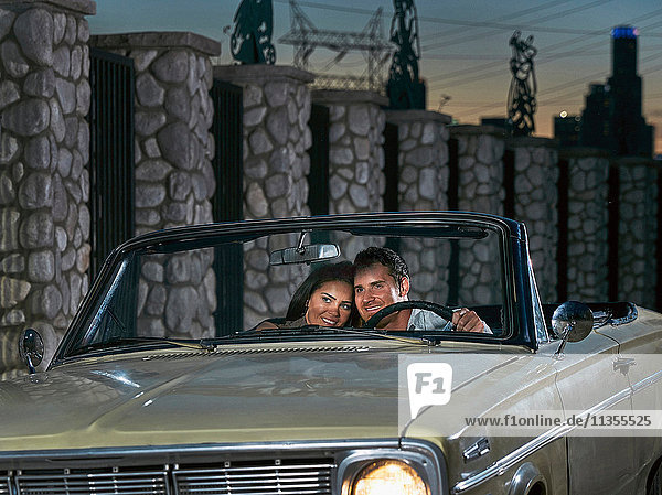 Couple in convertible car at dusk