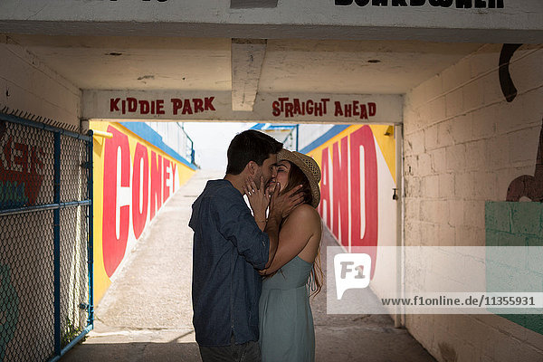 Couple in tunnel kissing  Coney island  Brooklyn  New York  USA