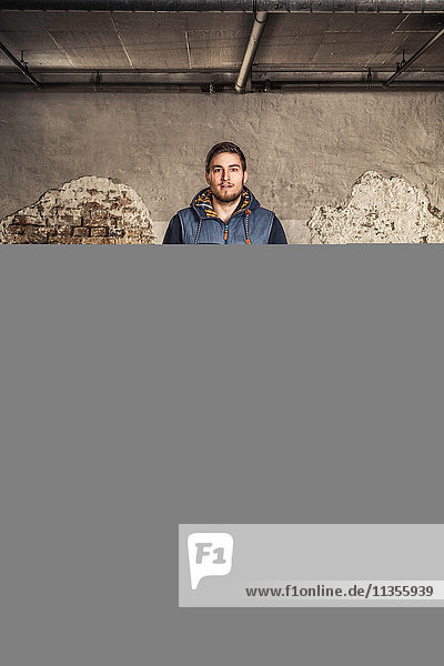 Portrait of man inside old warehouse