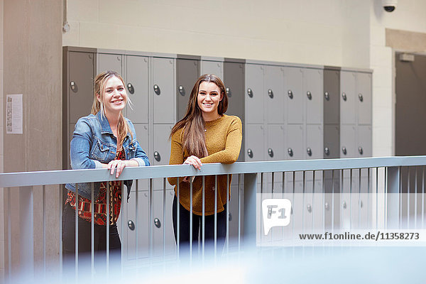 Portrait of two female students in higher education college locker room
