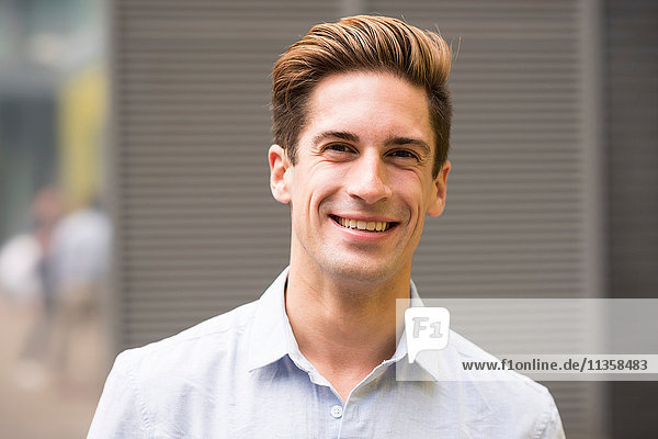 Portrait of smiling young businessman outside office  London  UK