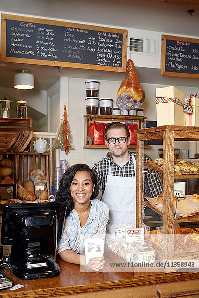 Portrait of male and female worker in bakery