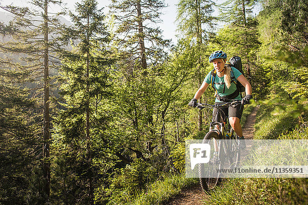 Woman mountain biking  Leermoos  Tyrol  Austria