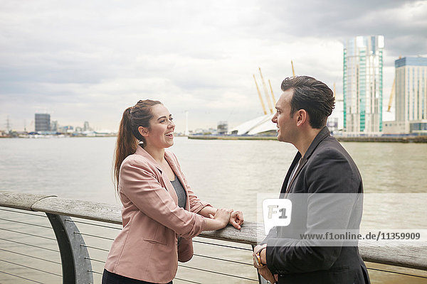 Businesswoman and businessman meeting on waterfront  London  UK