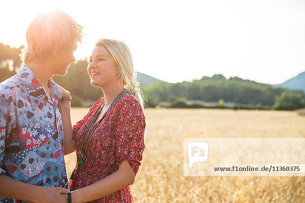 Romantic young couple holding hands in wheat field  Majorca  Spain