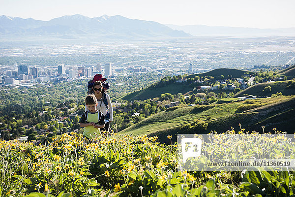 Mother with son and daughter  hiking the Bonneville Shoreline Trail in the Wasatch Foothills above Salt Lake City  Utah  USA