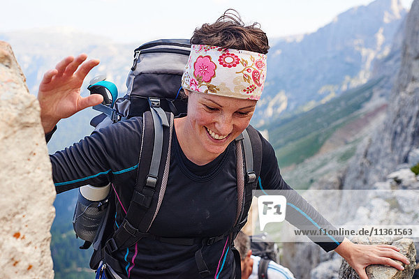 Woman hiking up mountain smiling  Austria