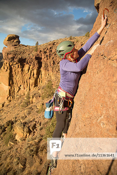 Female rock climber climbing mountain  Smith Rock State Park  Oregon  USA
