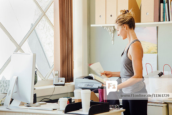 Woman in office holding paperwork