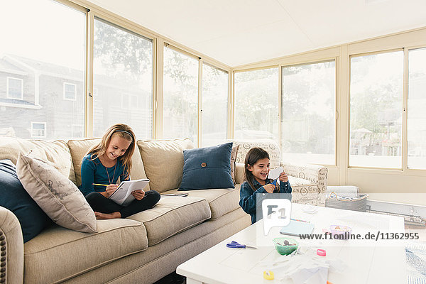 Girls at home doing arts and crafts