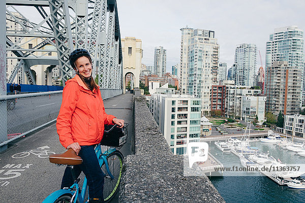 Porträt einer jungen Frau,  die bereit ist,  auf dem Fahrradweg Fahrrad zu fahren,  Vancouver,  Britisch-Kolumbien,  Kanada