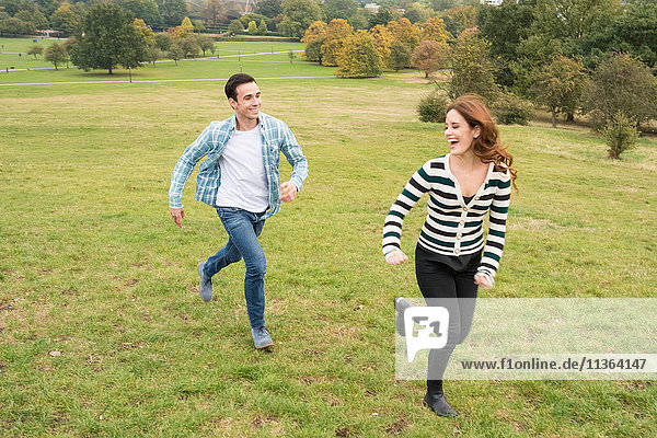 Couple running in field