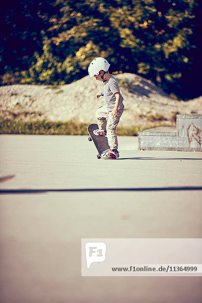 Boy skateboarding in park