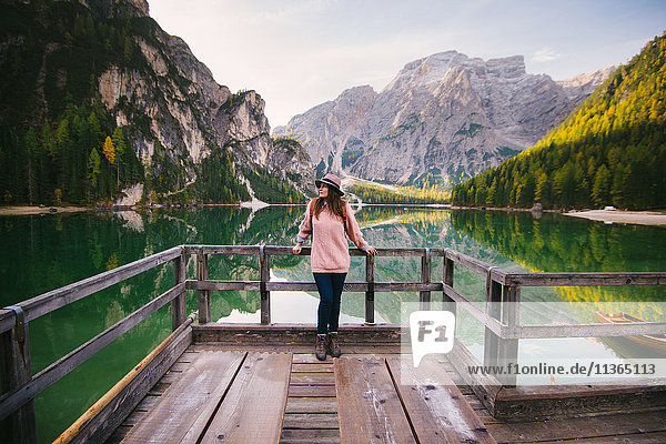 Woman leaning against wooden railing  Lago di Braies  Dolomite Alps  Val di Braies  South Tyrol  Italy