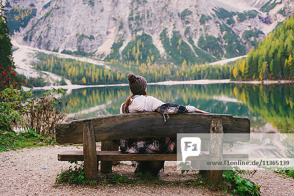 Woman relaxing on park bench  Lago di Braies  Dolomite Alps  Val di Braies  South Tyrol  Italy
