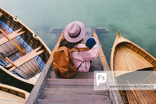 Woman relaxing on pier  Lago di Braies  Dolomite Alps  Val di Braies  South Tyrol  Italy