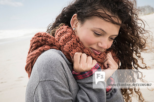 Portrait of young woman wrapped in scarf on windy beach  Western Cape  South Africa