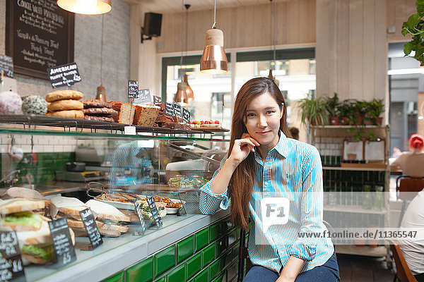 Portrait of mid adult woman in cafe