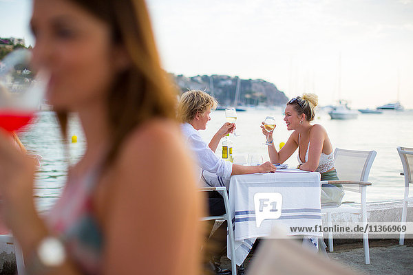 Background view of young couple at waterfront restaurant  Majorca  Spain