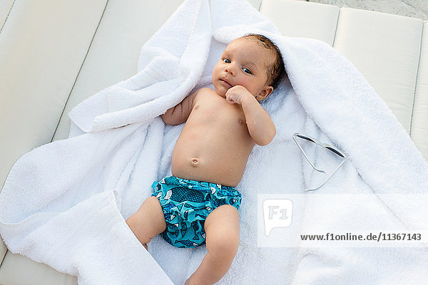 Baby lying on towel