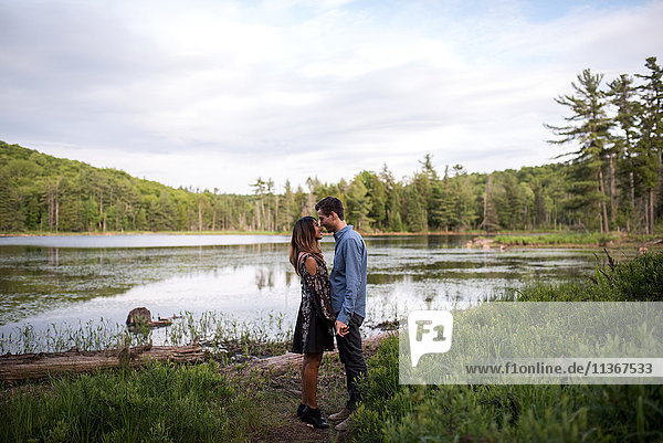 Couple rubbing noses by lake  Ottawa  Ontario