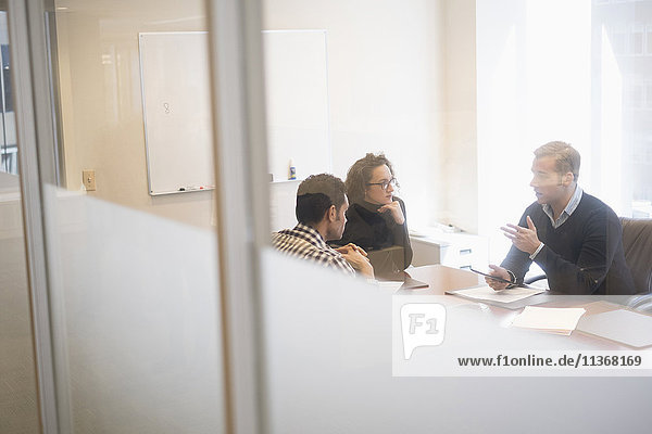 Young business people having meeting in board room