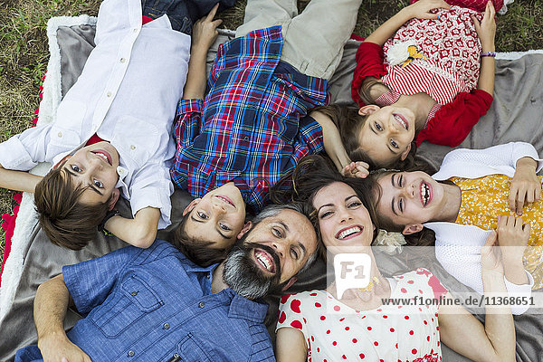 Family lying on grass