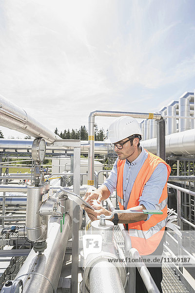Male engineer controlling measuring instrument at geothermal power station