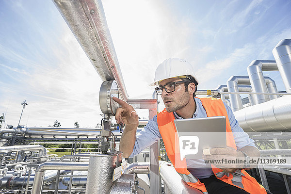 Male engineer controlling measuring instrument at geothermal power station