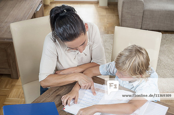 Woman helping her son with his homework