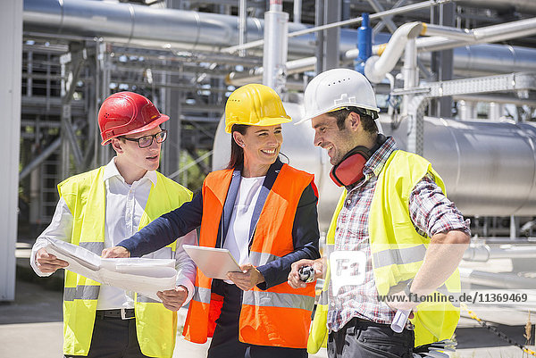 Engineer and workers in meeting on the area of a geothermal power station