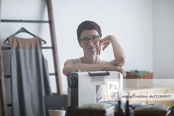 Portrait of a female dressmaker with sewing machine