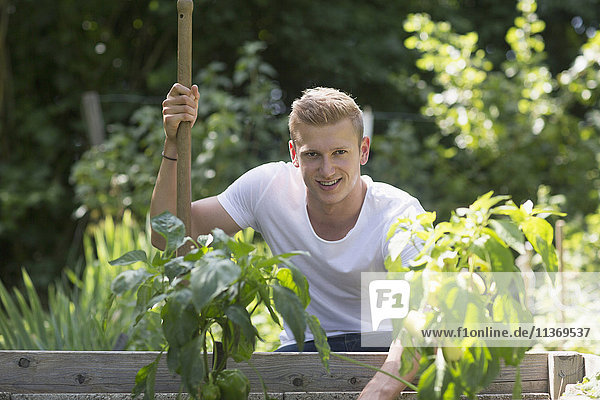 Young man working in urban garden