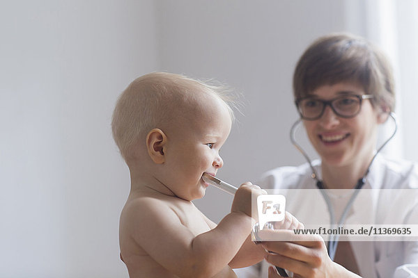Paediatrician examining baby boy in clinic  Freiburg im Breisgau  Germany