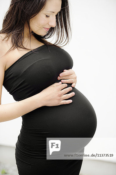 Pregnant woman touching her stomach