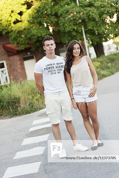Young couple standing on street
