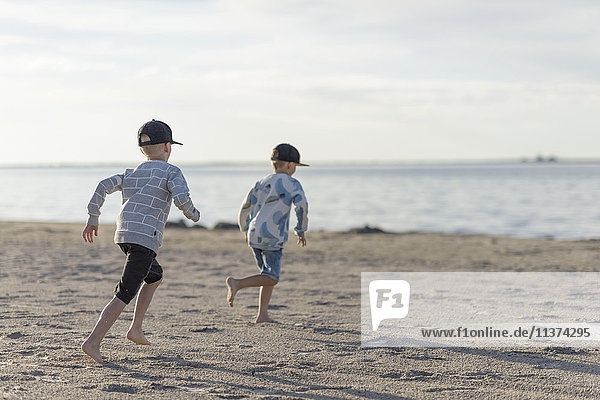 Boys running on beach