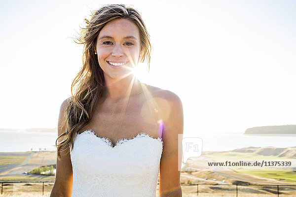 Caucasian bride smiling on sunny day