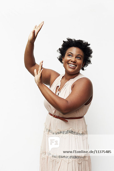 Portrait of smiling Black woman raising arms
