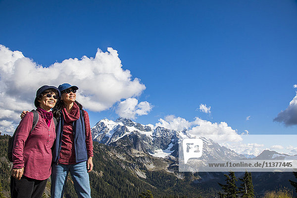 Ältere japanische Mutter und Tochter stehen in der Nähe eines Berges