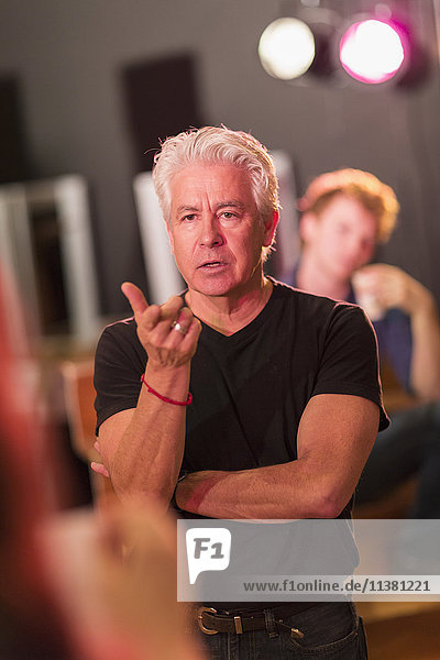 Teacher talking to students in theater class